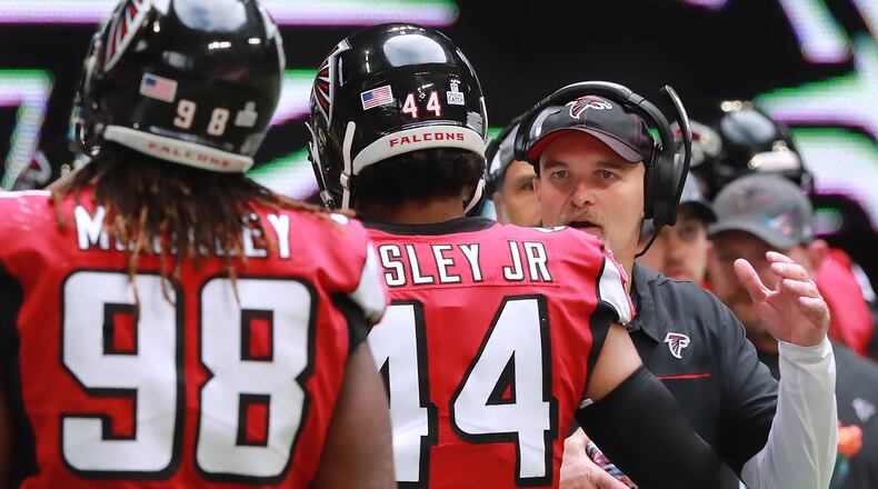 Atlanta Falcons head coach Dan Quinn encourages Vic Beasley Jr. and Takk McKinley as they come off the field after the Los Angeles Rams scored a touchdown following a Matt Ryan interception during the second half Sunday, Oct. 20, 2019, in Atlanta.