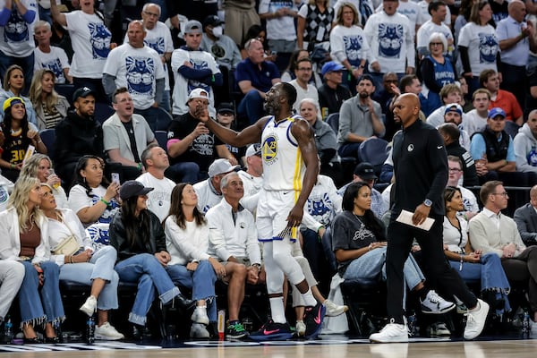 Golden State Warriors forward Draymond Green (23) reacts to the crowd during the first half of Game 2 of an NBA basketball second-round playoff series against the Minnesota Timberwolves, Thursday, May 8, 2025, in Minneapolis. (Carlos Avila Gonzalez/San Francisco Chronicle via AP)