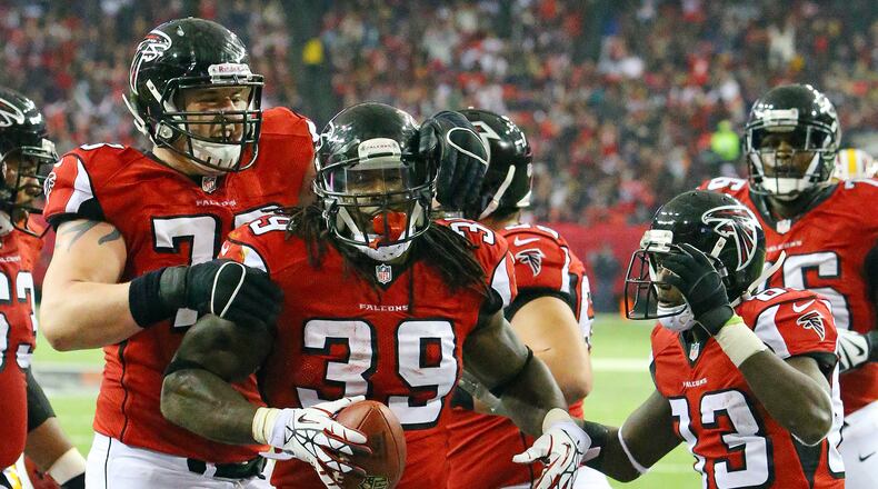 121513 ATLANTA: Falcons Ryan Schraeder (from left), Steven Jackson, and Harry Douglas celebrate Jackson's touchdown run for a 24-20 lead over the Redskins during the second half of a NFL football game on Sunday, Dec. 15, 2013, in Atlanta. CURTIS COMPTON / CCOMPTON@AJC.COM