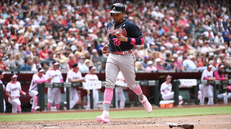Braves third baseman Johan Camargo scores a run on a single hit by Ender Inciarte during the second inning against the Arizona Diamondbacks Sunday, May 12, 2019, at Chase Field in Phoenix.