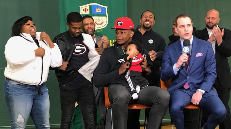 Anthony Edwards hold his 4-month-old nephew Jace as he announces his intention to play for Georgia.