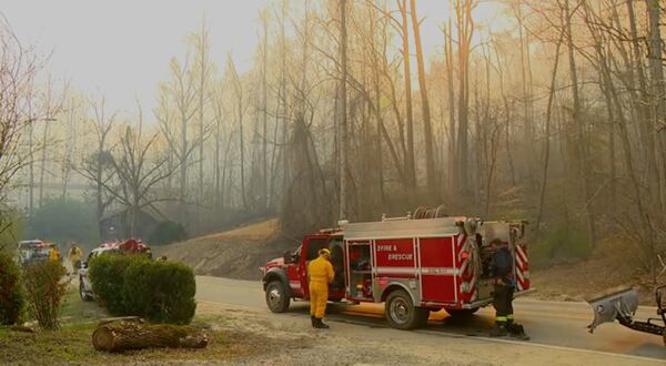 Firefighters prepare to fight the wildfires in Polk County, N.C., on Saturday, March 22, 2025. (WLOS-TV via AP)