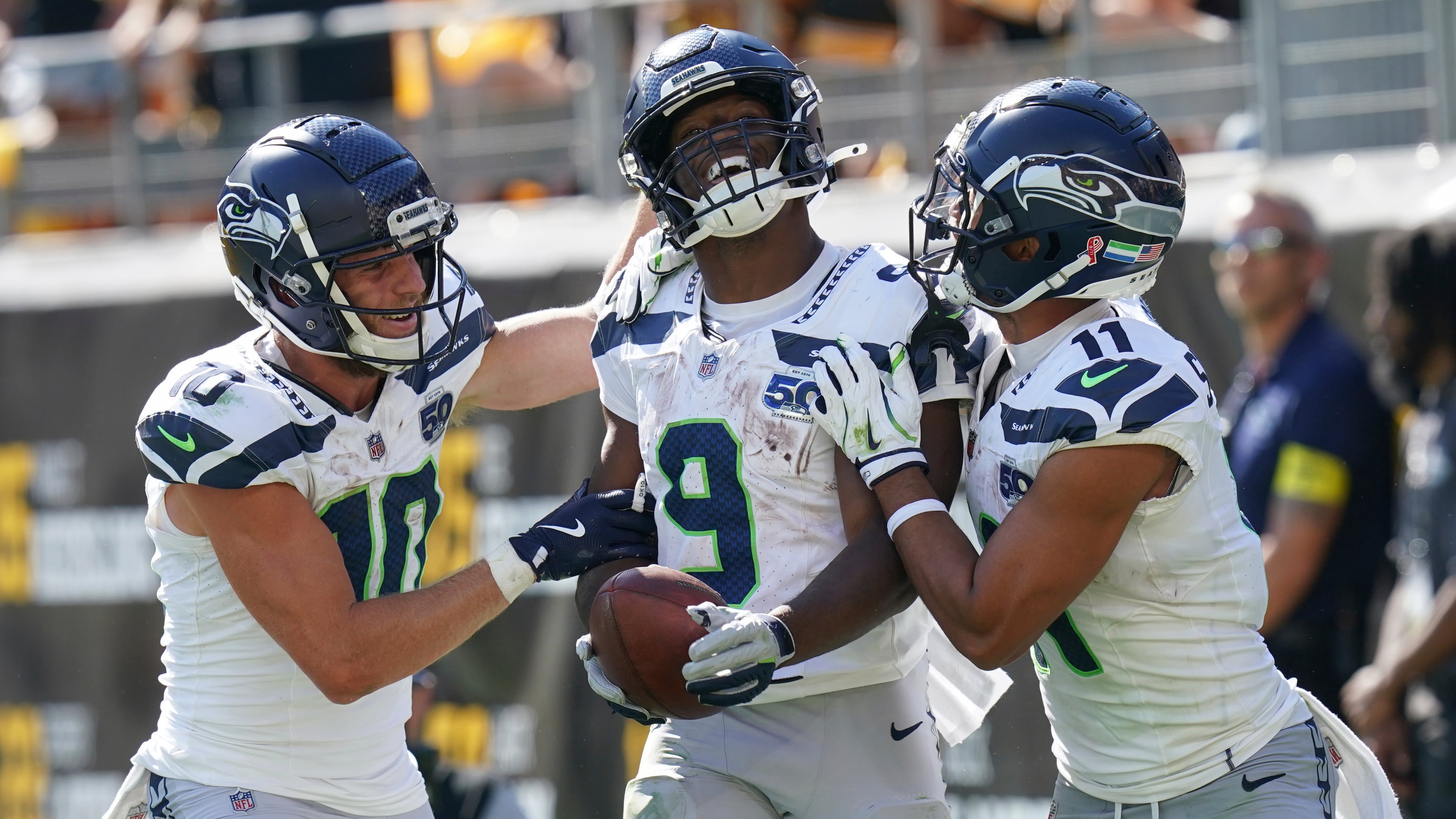 Seattle Seahawks running back Kenneth Walker III (9) celebrates a touchdown with wide receiver Cooper Kupp (10) and wide receiver Jaxon Smith-Njigba (11) during the second half of an NFL football game against the Pittsburgh Steelers, Sunday, Sept. 14, 2025, in Pittsburgh. (AP Photo/Matt Freed)