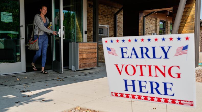 A voter walks out after voting at a polling place, Tuesday, July 28, 2026, in Milwaukee. (AP Photo/Nam Y. Huh)