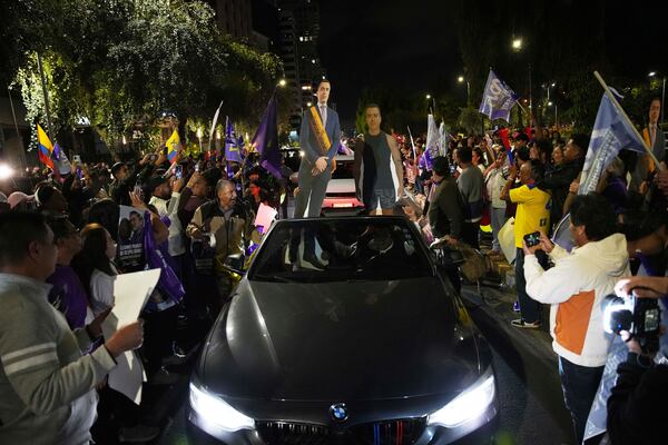 Supporters of President Daniel Noboa celebrate early returns showing him in the lead in the presidential election runoff in Quito, Ecuador, Sunday, April 13, 2025. (AP Photo/Carlos Noriega)