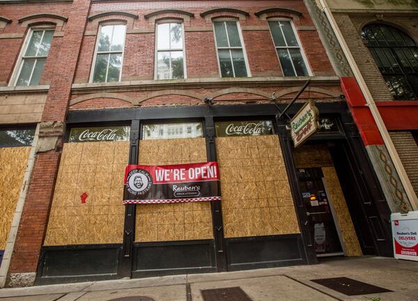 Reuben’s Deli and other businesses in the Fairlie-Poplar District were boarded up in June of last year, and some of them closed for weeks. (Jenni Girtman for The Atlanta Journal-Constitution)