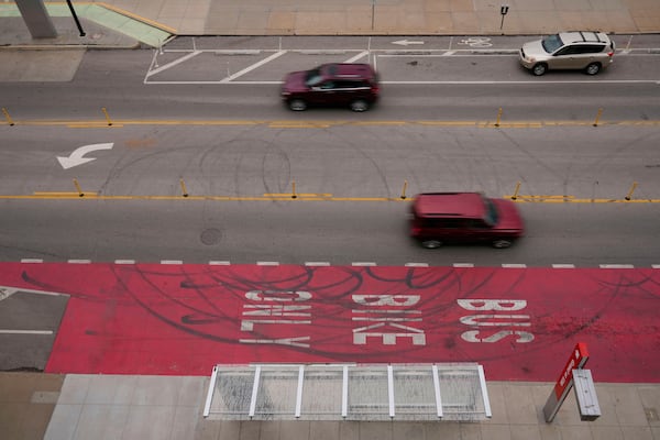 Cars drive on Grand Boulevard in Kansas City, Mo., where the city implemented a "road diet" reducing the street from four lanes to two in an effort to reduce speeding and accidents, Thursday, April 17, 2025. (AP Photo/Charlie Riedel)