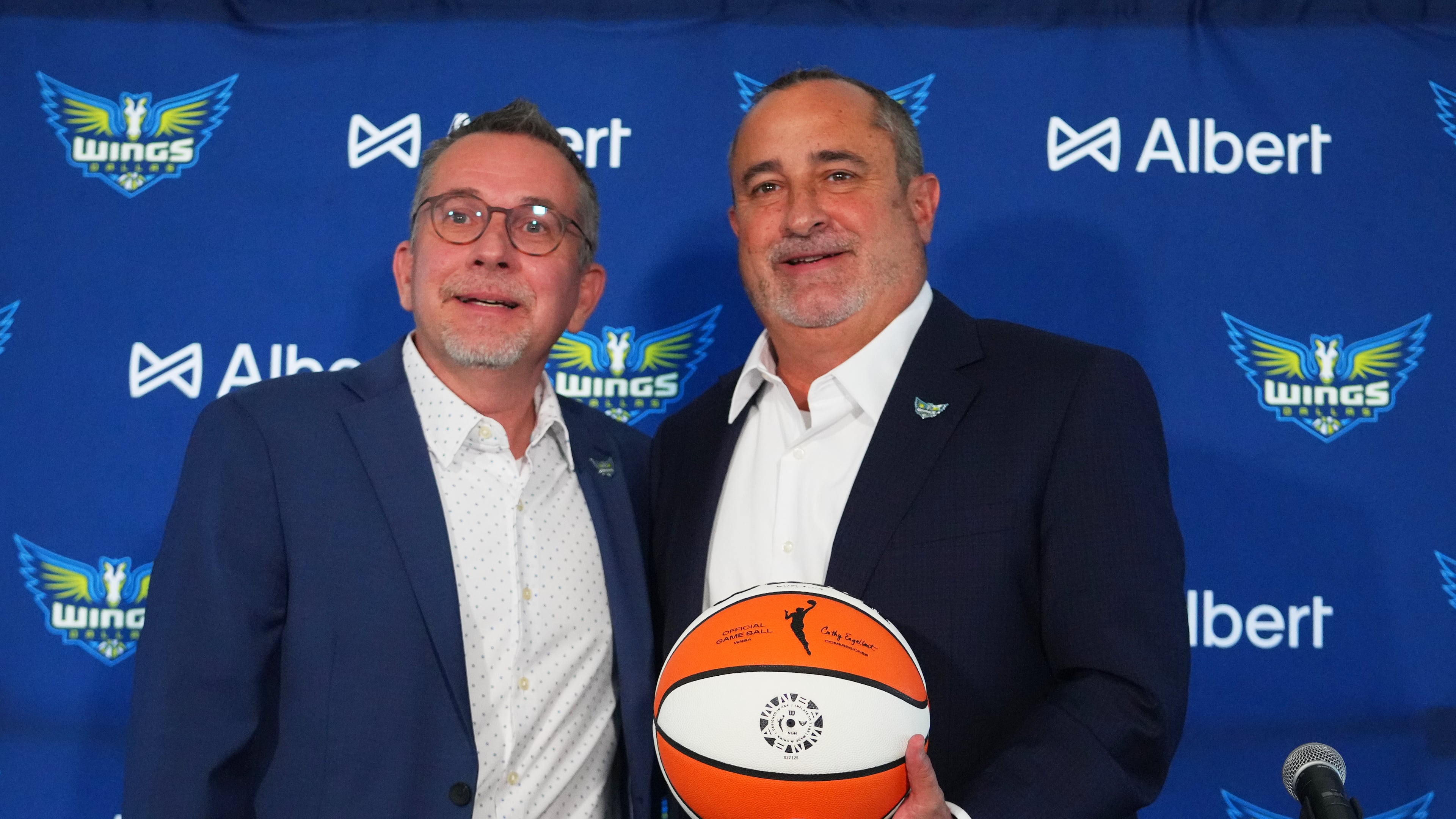 Dallas Wings general manager Curt Miller, left, poses for photographers with Jose Fernandez, right, during a news conference introducing Fernandez as the WNBA basketball team's new head coach, Thursday, Nov. 6, 2025, in Dallas. (AP Photo/Julio Cortez)