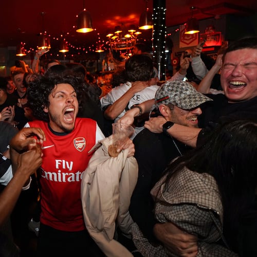 Arsenal supporters celebrate in a pub near the Arsenal stadium after Arsenal's soccer team won the Premier League title in London, Tuesday, May 19, 2026.(AP Photo/Alberto Pezzali)