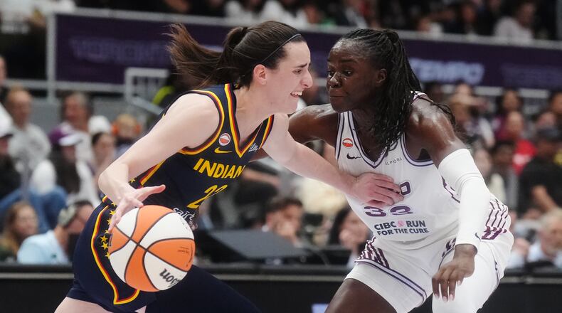 Indiana Fever's Caitlin Clark (22) drives as Toronto Tempo's Ornella Bankole (33) defends during first half WNBA basketball action in Toronto on Friday, Sept. 18, 2026. (Nathan Denette/The Canadian Press via AP)