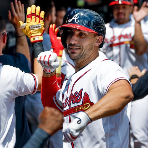 Atlanta Braves' Matt Olson, right, celebrates in the dugout with Jorge Mateo, left, after hitting a three-run home run against the Philadelphia Phillies during the first inning of a baseball game, Sunday, April 26, 2026, in Atlanta. (AP Photo/Erik S. Lesser)
