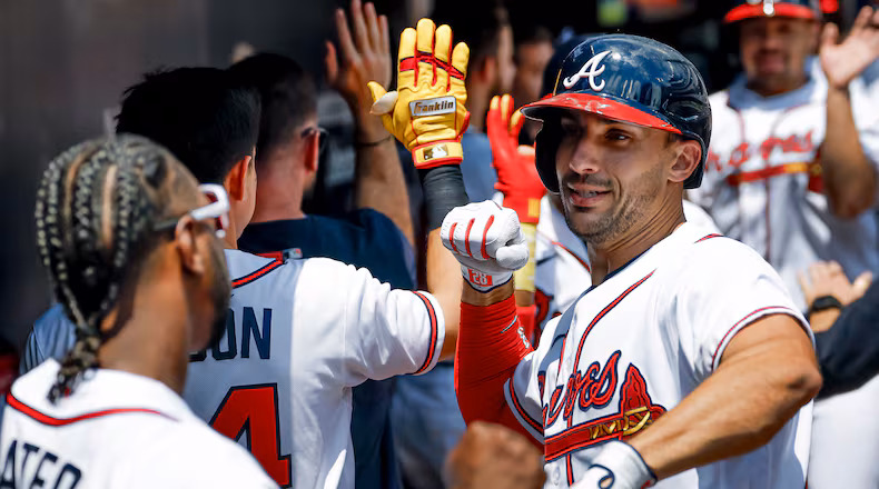 Atlanta Braves' Matt Olson, right, celebrates in the dugout with Jorge Mateo, left, after hitting a three-run home run against the Philadelphia Phillies during the first inning of a baseball game, Sunday, April 26, 2026, in Atlanta. (AP Photo/Erik S. Lesser)