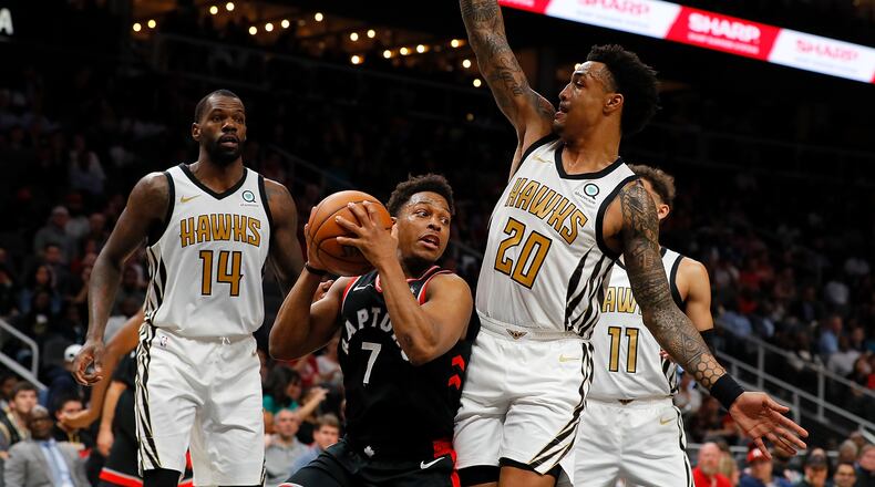 John Collins #20 of the Atlanta Hawks defends against Kyle Lowry #7 of the Toronto Raptors at State Farm Arena. (Photo by Kevin C. Cox/Getty Images)
