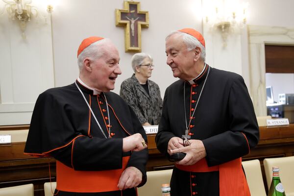 FILE - Cardinal Marc Ouellet, left, talks with Cardinal Vincent Nichols, before the start of an event to celebrate the Canonization of Cardinal John Henry Newman who will be named a Saint in a ceremony presided by Pope Francis on Sunday, at the Vatican, Saturday, Oct. 12, 2019. (AP Photo/Alessandra Tarantino, file)