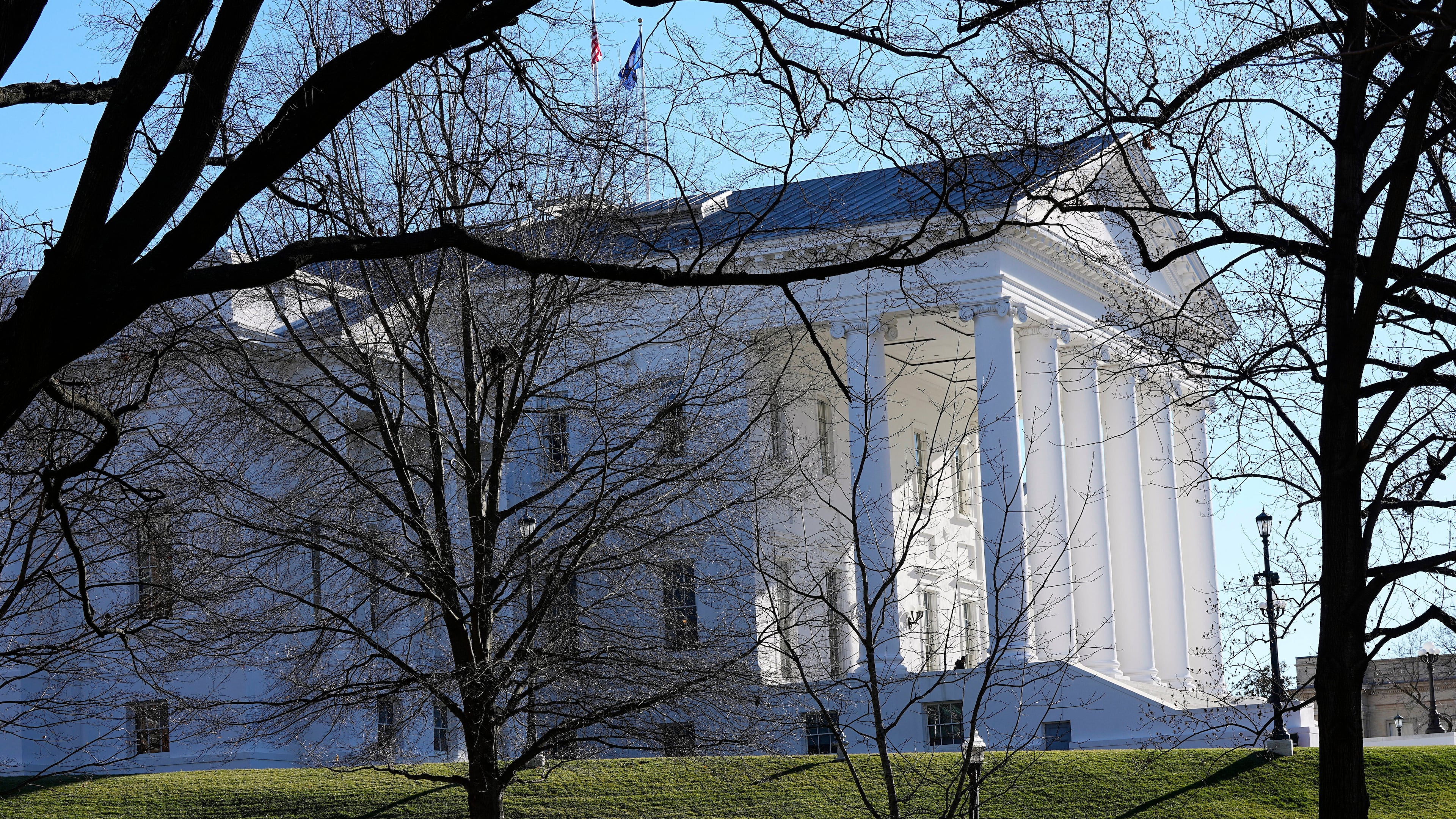 FILE - The state and U.S. flags fly over the Virginia State Capitol as the 2024 session of the Virginia General Assembly gets underway, Jan. 10, 2024, in Richmond, Va. (AP Photo/Steve Helber, File)