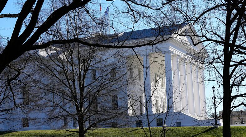 FILE - The state and U.S. flags fly over the Virginia State Capitol as the 2024 session of the Virginia General Assembly gets underway, Jan. 10, 2024, in Richmond, Va. (AP Photo/Steve Helber, File)