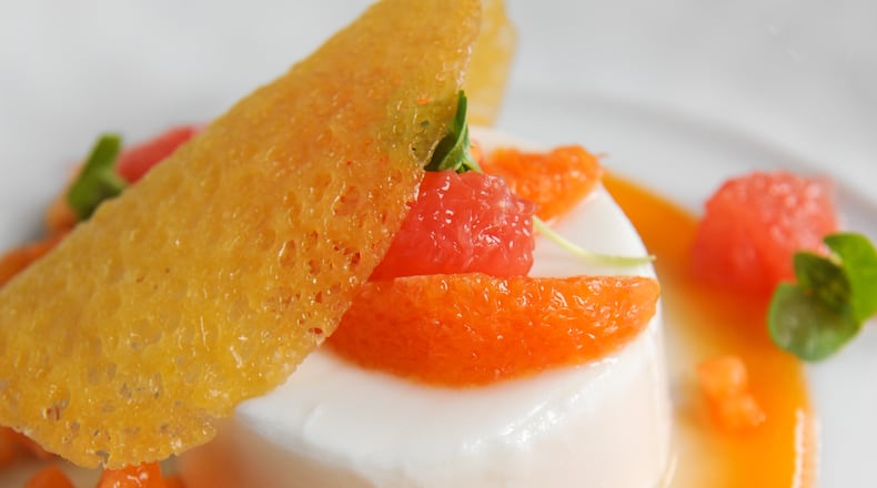 150305-ATLANTA-GA- John Kessler's restaurant review of Atlas, inside the Buckhead St. Regis, on Thursday March 5, 2015. FOOD: Coconut Panna Cotta- Coconut -Almond Milk Custard, Citrus Fruits, Papaya Coulis, Coconut Crisp.(www.Beckysteinphotography.com) Coconut panna cotta