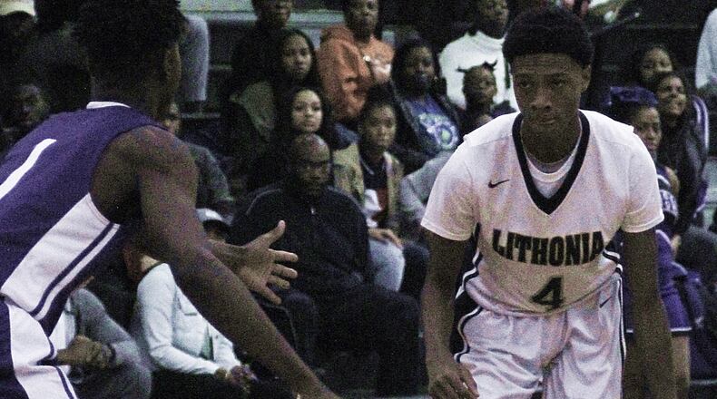 Lithonia's Eric Gaines gets ready to drive on Miller Grove's Maurice Harvey.