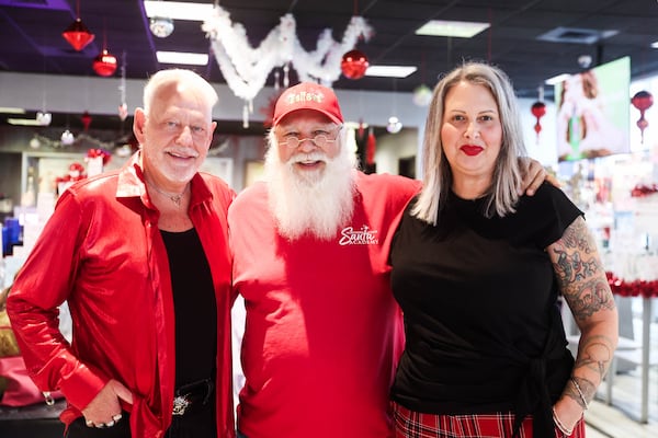 Salon Manager Lester E. Crowell Jr. poses for a portrait with Cesar Janeira and Shannon Woodard at Three-13 Salon in Marietta, Ga., on Tuesday, November 25, 2025. Woodard is one of the stylists who preps Atlanta’s working Santas for the season. (Abbey Cutrer / AJC)