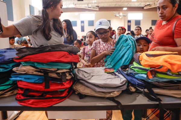 Students and their families choose backpacks at Cobb County’s 2nd Annual Back-to-School Bash at Pearson Middle School in Marietta on Friday, July 25, 2025. (Natrice Miller/ AJC)