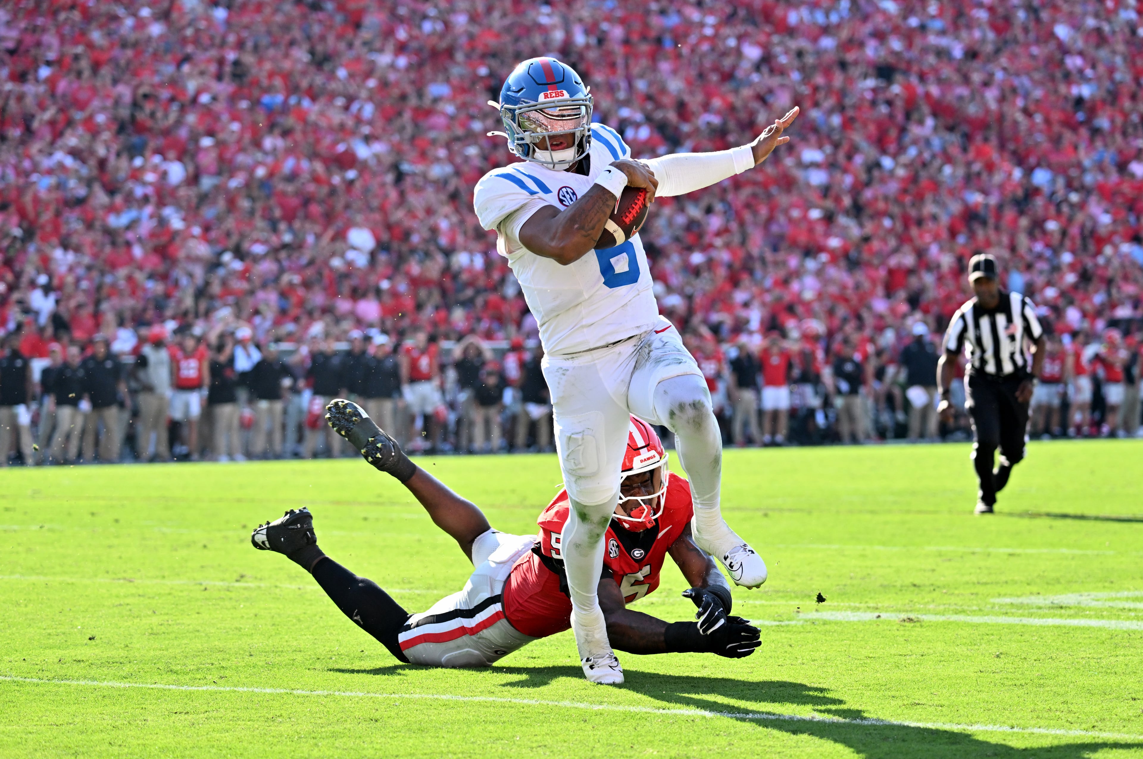 Mississippi quarterback Trinidad Chambliss (6) runs past Georgia linebacker Raylen Wilson (5) for a touchdown during the first half in an NCAA football game at Sanford Stadium, Saturday, October 18, 2025, in Athens. (Hyosub Shin / AJC)