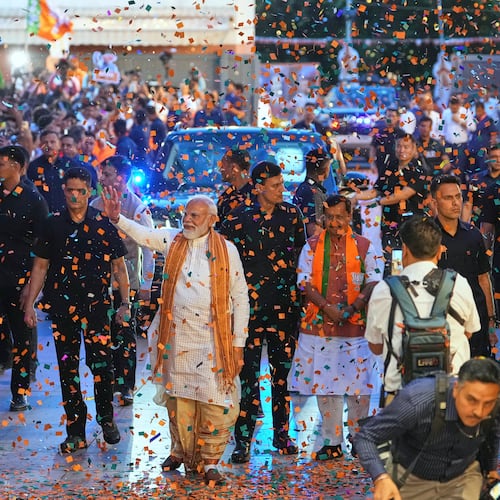 Confetti is sprayed as Indian Prime Minister Narendra Modi, center, waves to supporters upon his arrival at the Bharatiya Janata Party (BJP) headquarters to celebrate victory in the recently held state assembly elections in New Delhi, India, Monday, May 4, 2026. (AP Photo/Manish Swarup)