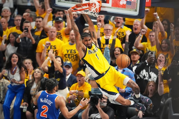 Indiana Pacers forward Obi Toppin (1) dunks the ball over New York Knicks guard Miles McBride (2) during the first half of Game 4 of the Eastern Conference finals of the NBA basketball playoffs in Indianapolis, Tuesday, May 27, 2025. (AP Photo/Michael Conroy)