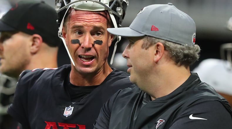 Falcons quarterback Matt Ryan confers with head coach Arthur Smith as they prepare to play the Cleveland Browns in the final exhibition game of the preseason Sunday, Aug. 29, 2021, at Mercedes-Benz Stadium in Atlanta. (Curtis Compton / Curtis.Compton@ajc.com)
