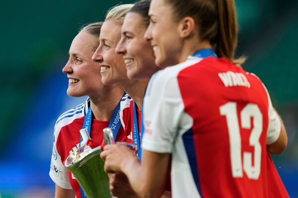 From left, Arsenal's Kim Little, Leah Williamson, Steph Catley and Lia Walti pose with the winner trophy after their team won the women's Champions League final soccer match between Arsenal and FC Barcelona at the Jose Alvalade stadium in Lisbon, Saturday, May 24, 2025. (AP Photo/Armando Franca)