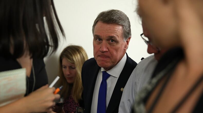 U.S. Sen. David Perdue (R-Ga.) walks in the U.S. Capitol before all-night voting on July 27, 2017. (Photo by Justin Sullivan/Getty Images)