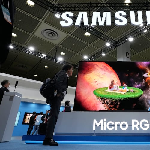 Visitors watch a Samsung Electronics' Micro RGB TV at its booth during the World IT Show in Seoul, South Korea, Wednesday, April 22, 2026. (AP Photo/Ahn Young-joon)