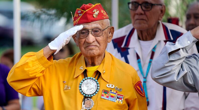 FILE - Navajo Code Talker Thomas Begay salutes during the national anthem at the Arizona State Navajo Code Talkers Day celebration, Aug. 14, 2022, in Phoenix. (AP Photo/Ross D. Franklin, File)