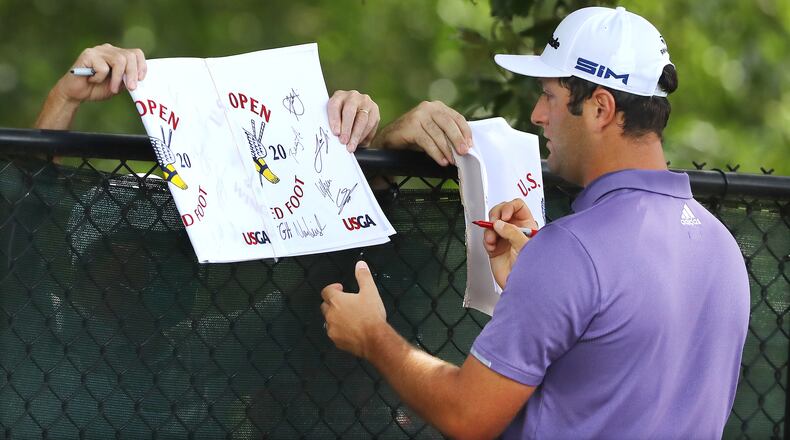 Fans are allowed on East Lake this week for the Tour Championship, but a few worked the fence line along No. 3 Thursday for autographs. And Jon Rahm stopped to oblige. “Curtis Compton / Curtis.Compton@ajc.com”
