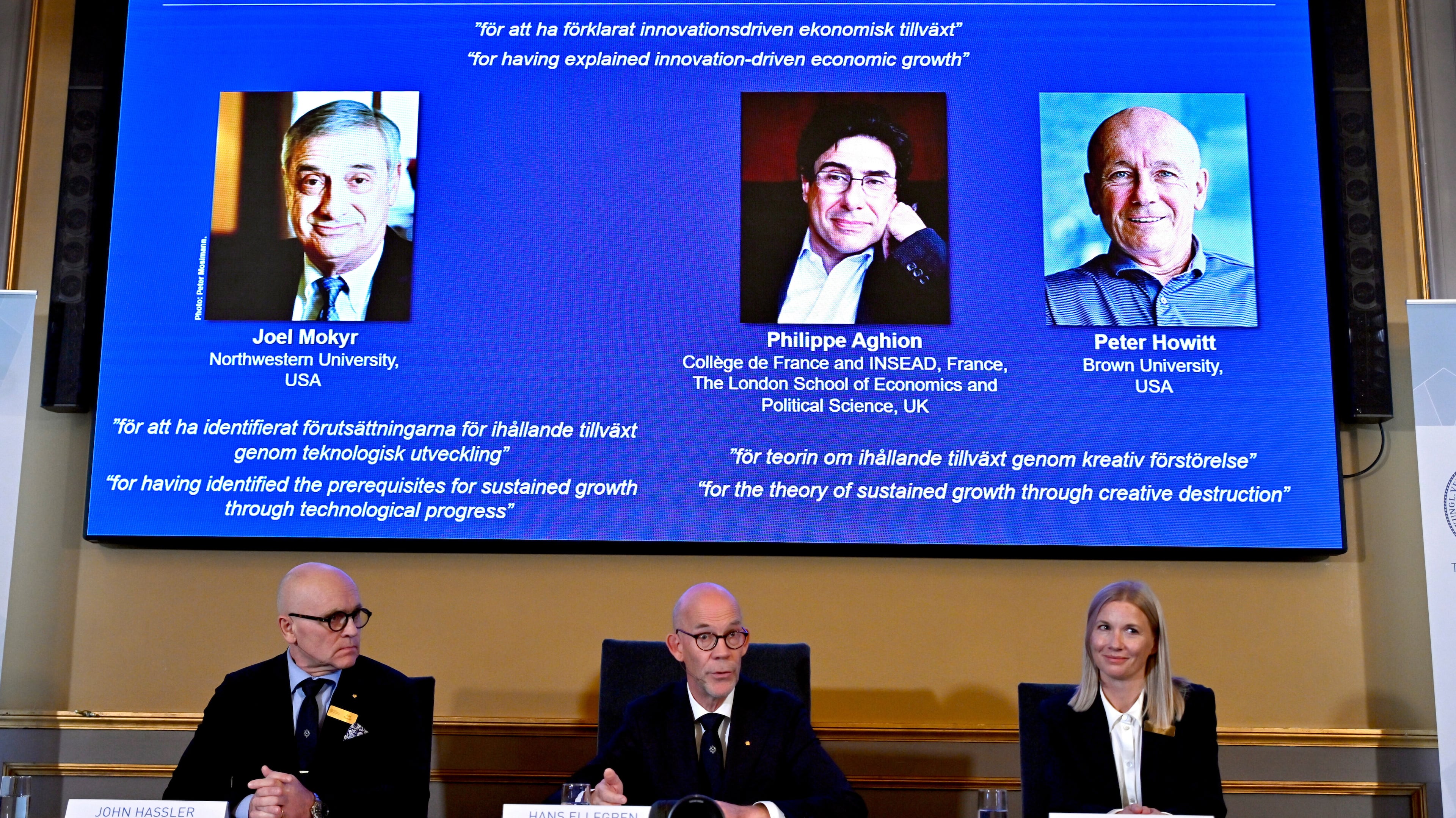 Professor John Hassler, from left, Hans Ellegren, Permanent Secretary of the Academy of Sciences and Professor Kerstin Enflo, announce Joel Mokyr, Philippe Aghion and Peter Howitt as the recipients of the Nobel Memorial Prize in Economics during a press conference at the Royal Swedish Academy of Sciences in Stockholm, Sweden, Monday, Oct. 13, 2025. (Anders Wiklund/TT News Agency via AP)