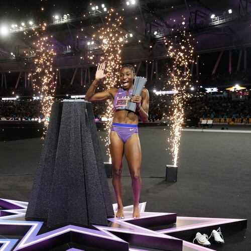 Melissa Jefferson-Wooden, of the United States, poses with her trophy after winning the women's 200 meters final at the World Athletics Ultimate Championship in Budapest, Hungary, Sunday, Sept. 13, 2026. (AP Photo/Matthias Schrader)