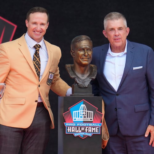 Former NFL player Drew Brees, left, unveils his bust with Sean Payton during the Pro Football Hall of Fame induction ceremony at the Pro Football Hall of Fame, in Canton, Ohio, Saturday, Aug. 8, 2026. (AP Photo/Sue Ogrocki)