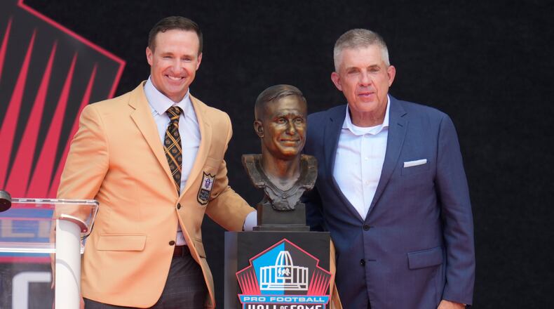 Former NFL player Drew Brees, left, unveils his bust with Sean Payton during the Pro Football Hall of Fame induction ceremony at the Pro Football Hall of Fame, in Canton, Ohio, Saturday, Aug. 8, 2026. (AP Photo/Sue Ogrocki)