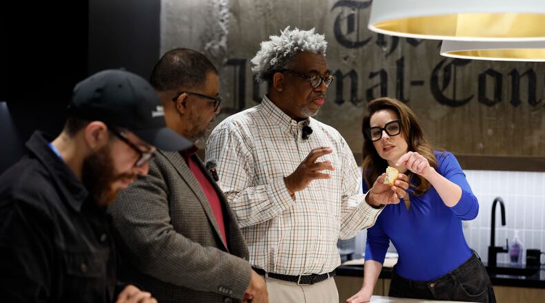 AJC Senior Food & Dining Editor Monti Carlo, right, helps Race and Culture Reporter Ernie Suggs analyze the flavors of a biscuit, while AJC Editor-in-Chief Leroy Chapman Jr. and Director of Social Media Travis Lyles enjoy them during a tasting contest to find the best biscuit in Atlanta on Tuesday, April 28, 2026. (Miguel Martinez/AJC)