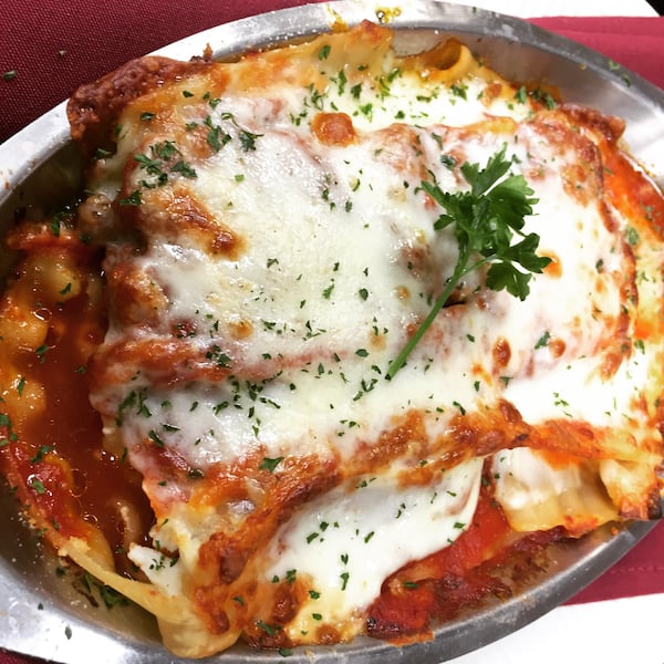 A top-down view of a large plate of lasagna.