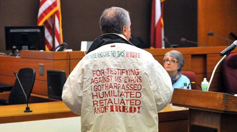 Defense attorney Robert Rubin dons a jacket once worn by a witness who testified against his client, former Dobbs Elementary principal Dana Evans, during his closing argument Monday afternoon in the Atlanta Public Schools test-cheating trial. Rubin said the allegations on the jacket were part of the public shaming of his client during the course of the trial. The jacket first surfaced in the trial in January, when former Dobbs paraprofessional Naomi Williams testified that in 2009 she was fired within days of telling Evans that a teacher had asked her to change answers on a student’s standardized test. Williams testified that before she was fired, she filed complaints with the school district. And she said that in 2010, she wore a special jacket to a public meeting with the APS superintendent that bore this message on the back: “For testifying against Ms. Evans, I got harassed, humiliated, retaliated and fired.” (Kent D. Johnson, The Atlanta Journal-Constitution)