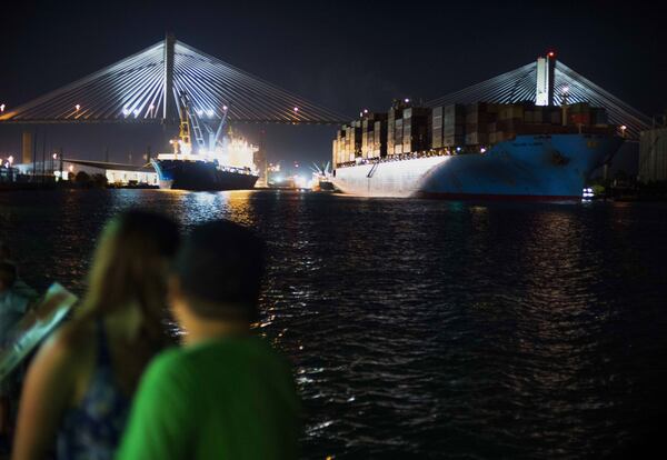 Pedestrians watch from River Street as a cargo ship leaves the Port of Savannah heading toward the Talmadge Memorial Bridge in Savannah, Ga., on Aug. 15, 2015. CREDIT: Bloomberg photo by Ty Wright