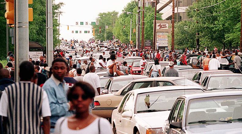 Freaknik revelers bring Lenox Road traffic to a standstill after Lenox Square and Phipps Plaza malls closed early on a Saturday in 1995.