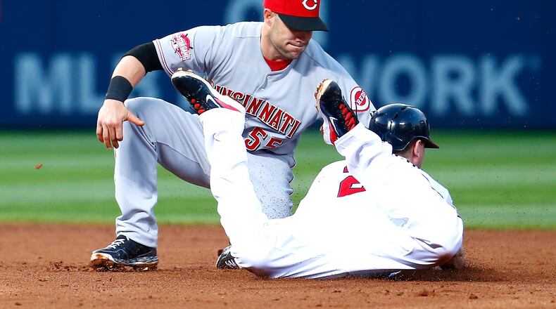 Chris Johnson #23 of the Atlanta Braves is caught stealing second base by Skip Schumaker #55 of the Cincinnati Reds in the fourth inning at Turner Field on April 30, 2015 in Atlanta, Georgia. (Photo by Kevin C. Cox/Getty Images)