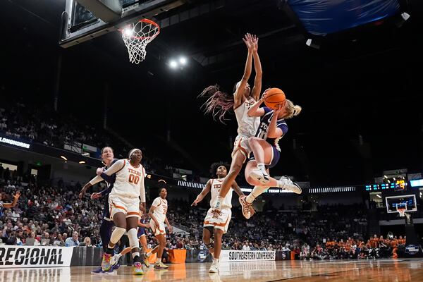 TCU guard Hailey Van Lith (10) goes to the basket against Texas guard Ndjakalenga Mwenentanda during the second half in the Elite Eight of the NCAA college basketball tournament, Monday, March 31, 2025. in Birmingham, Ala. (AP Photo/Gerald Herbert)