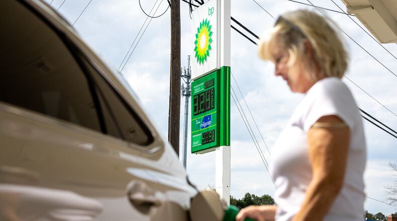 Mickey Merkel pumps gas in Duluth recently. Prices at the pump were on the rise as the Memorial Day holiday approached. (Arvin Temkar / arvin.temkar@ajc.com)