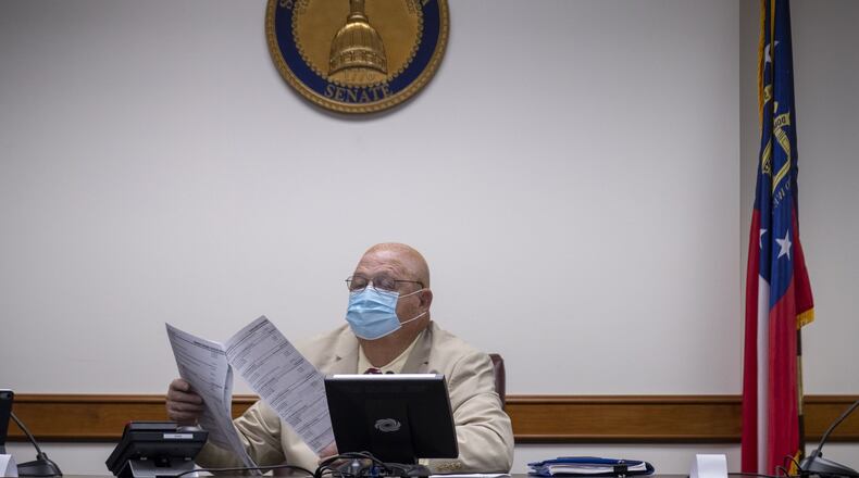 Sen. Ellis Black (R - Valdosta), head of the Senate education budget subcommittee, looks through paperwork during a meeting at the State Capitol. (ALYSSA POINTER / ALYSSA.POINTER@AJC.COM)