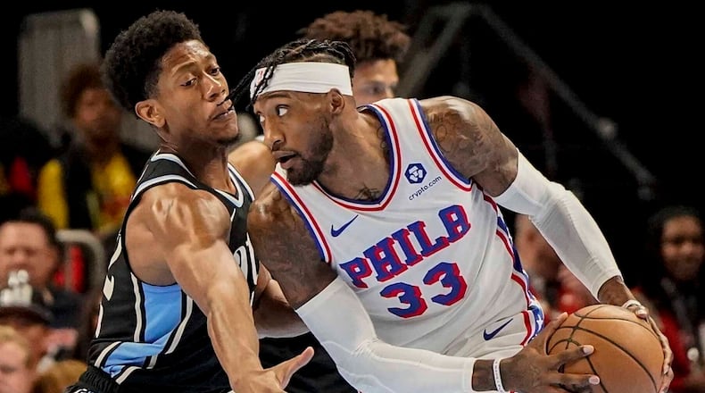 Philadelphia 76ers forward Robert Covington (33) drives against Atlanta Hawks forward De'Andre Hunter (12) during the first half of an In-Season Tournament NBA basketball game, Friday, Nov. 17, 2023, in Atlanta. (AP Photo/Mike Stewart)