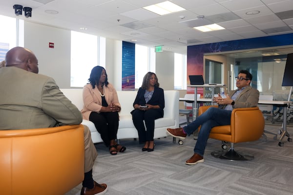 Georgia Technology Authority Chief Digital and Artificial Intelligence Officer Nikhil Deshpande (far right) speaks to the AJC at the GTA earlier this month. (Jason Getz/AJC)