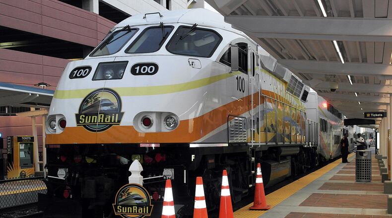 Locomotive pulls rail cars for SunRail, metro Orlando's new commuter line, which opened May 1.