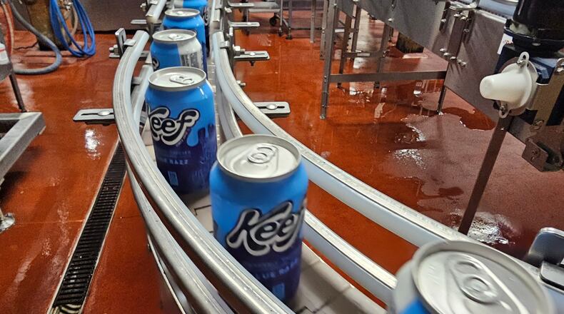 Cans of seltzer containing THC, the active ingredient in marijuana, speed down the canning line at Indeed Brewing in Minneapolis on Thursday, Nov. 20, 2025. (AP Photo/Steve Karnowski)